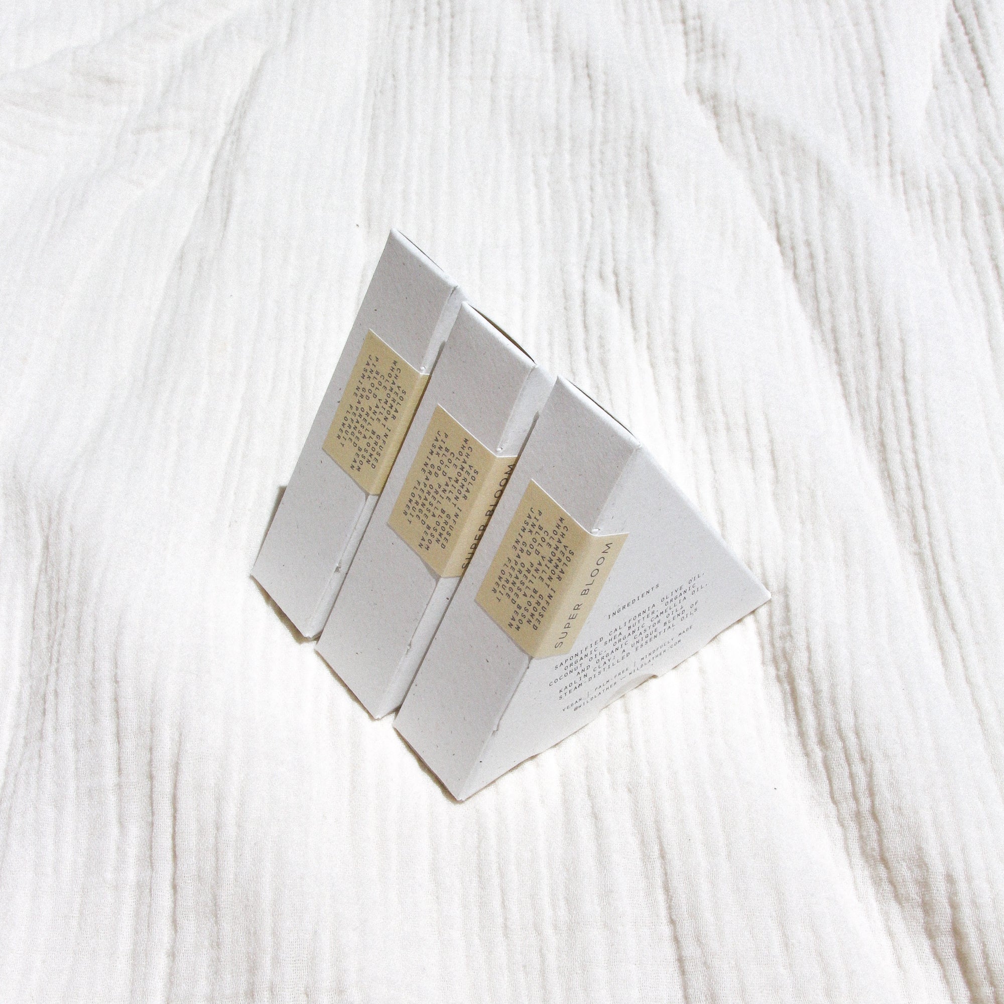 Three packaged triangle soaps lined up