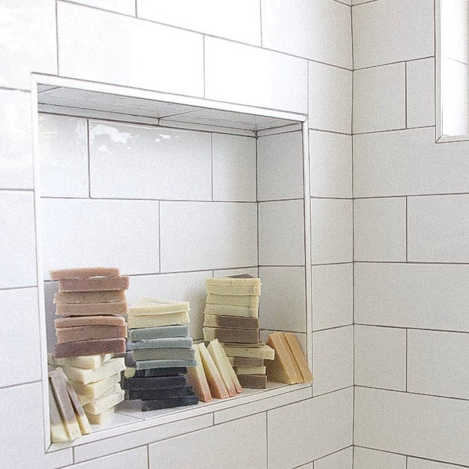 Soap ends stacked up in a tiled shower nook