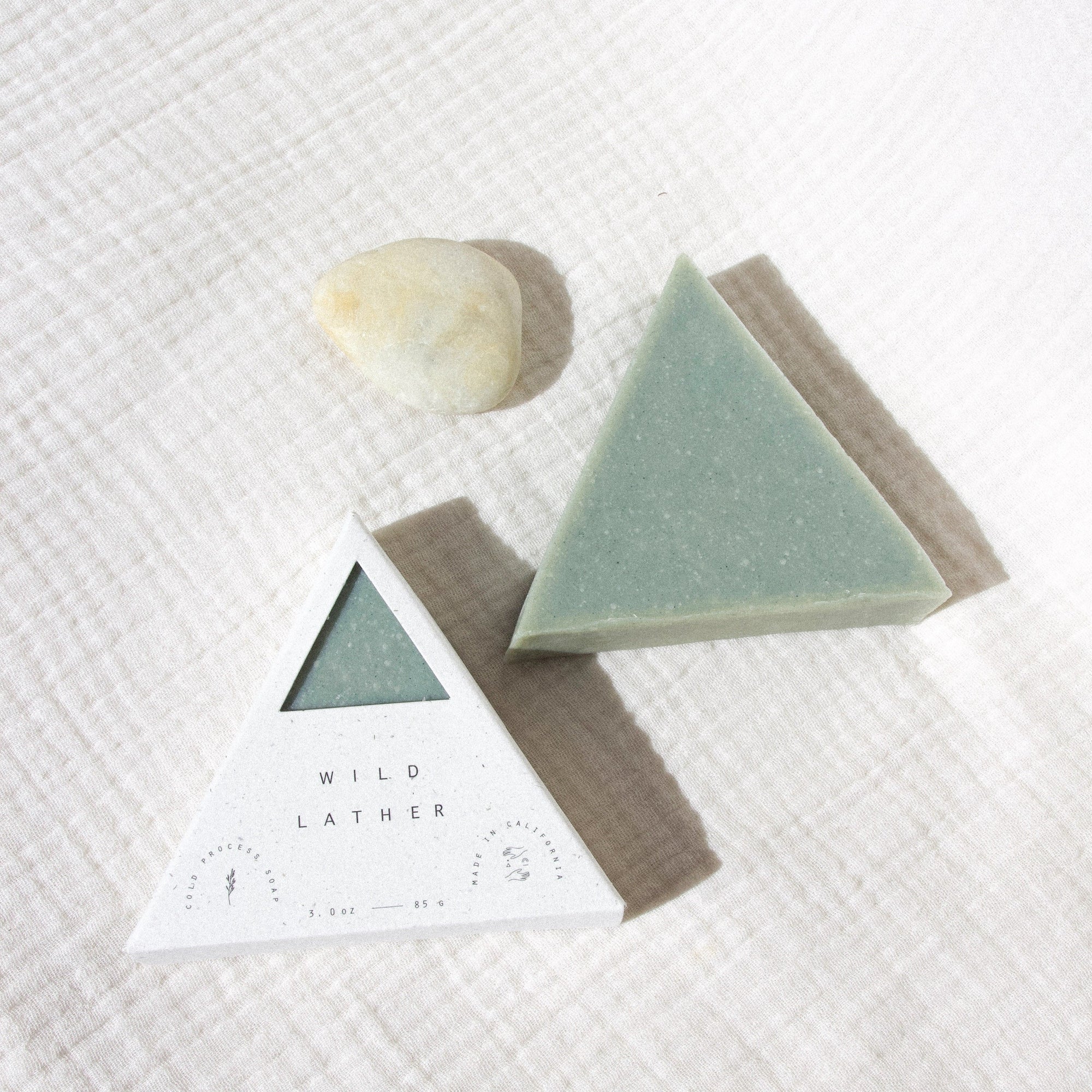 Indigo blue triangle soap packaged in a speckled white box