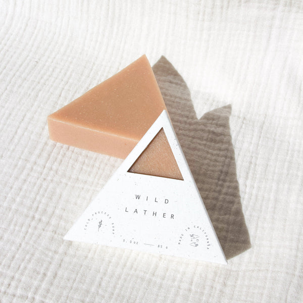 Pink clay soap packaged in a speckled white triangle box