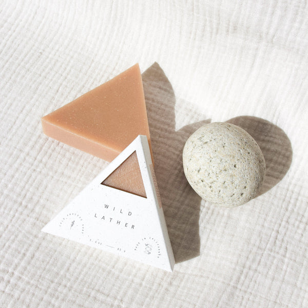 Pink clay soap packaged in a speckled white triangle box