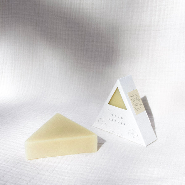 Two triangle soaps against a textured cream cloth