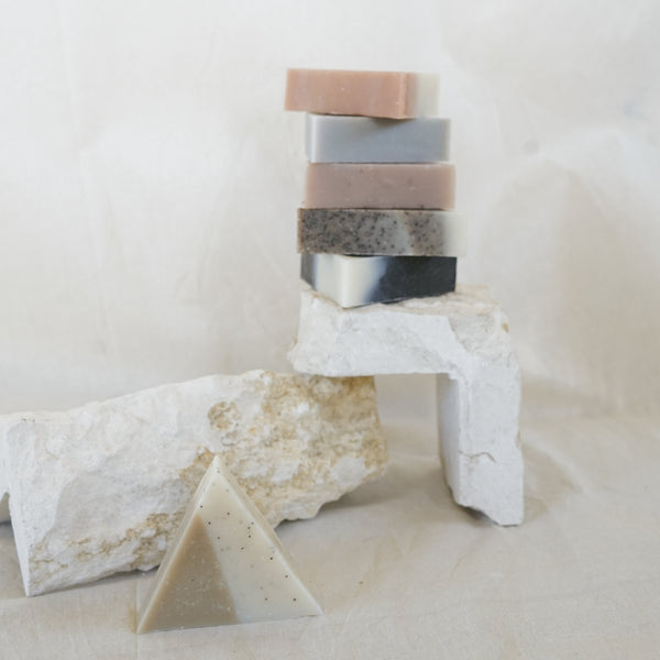 Six triangle soaps stacked on balancing stones