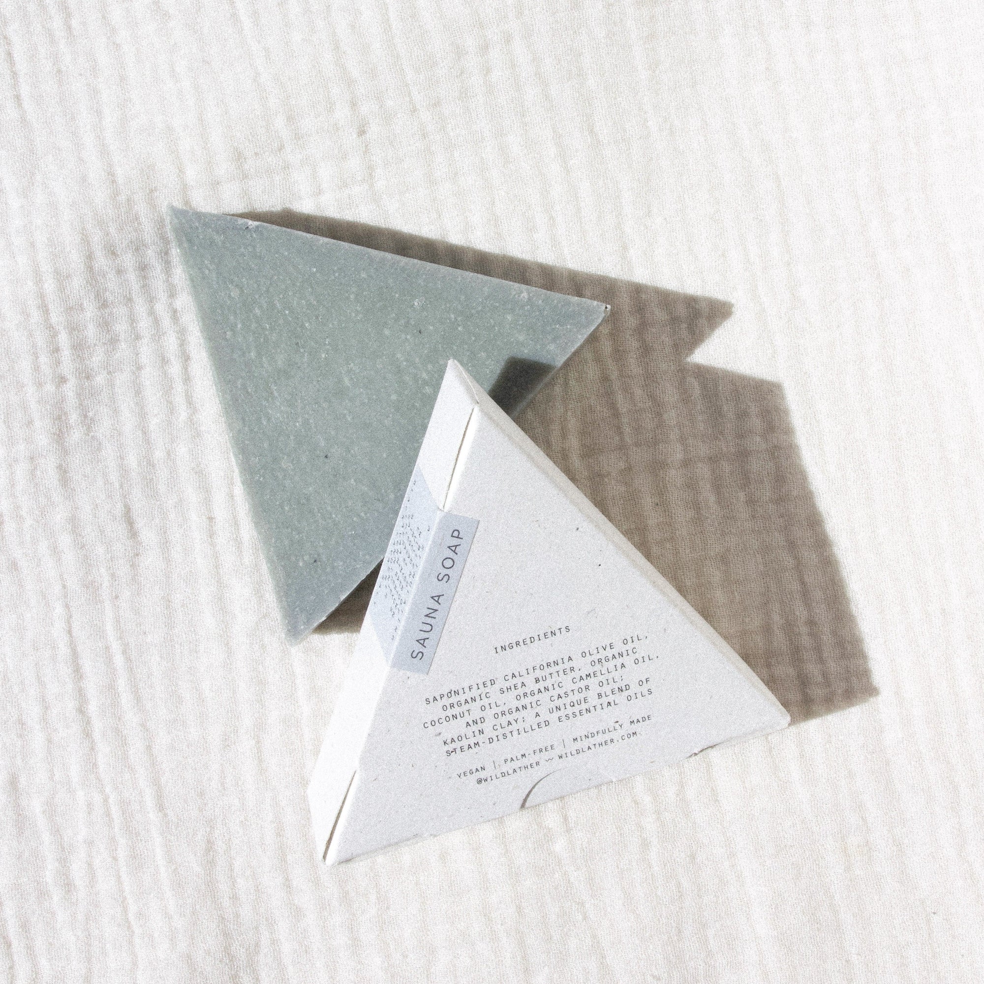 Two triangle soaps against textured linen
