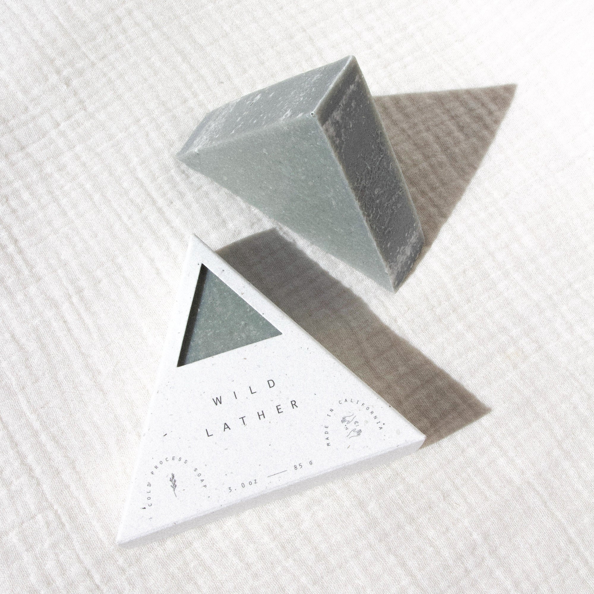 Two triangle soaps against textured linen